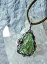 Transparent green 2.0 g Moldavite pendant from Maruškovo Pole wrapped in stainless steel wire with a gold-plated round bead