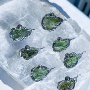 Transparent green 2.0 g Moldavite pendant from Maruškovo Pole wrapped in stainless steel wire with a gold-plated round bead