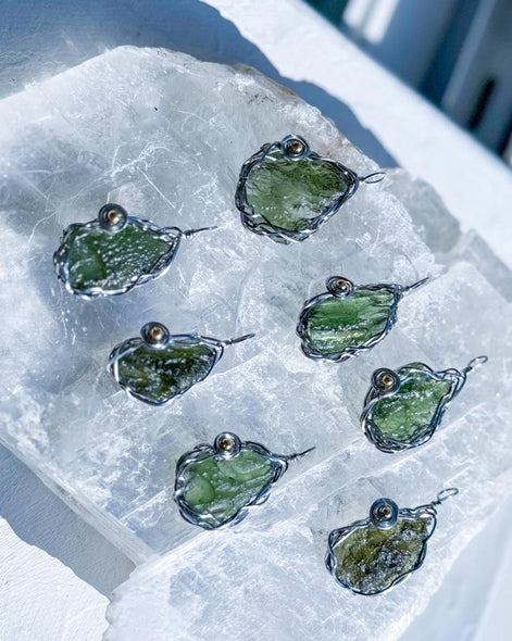 Transparent green 2.0 g Moldavite pendant from Maruškovo Pole wrapped in stainless steel wire with a gold-plated round bead