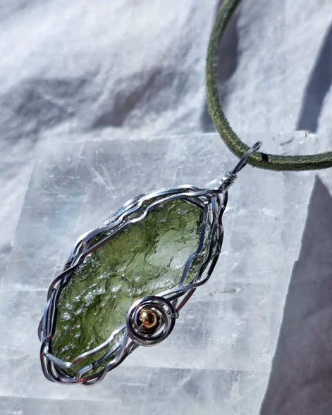 Transparent green 2.0 g Moldavite pendant from Maruškovo Pole wrapped in stainless steel wire with a gold-plated round bead