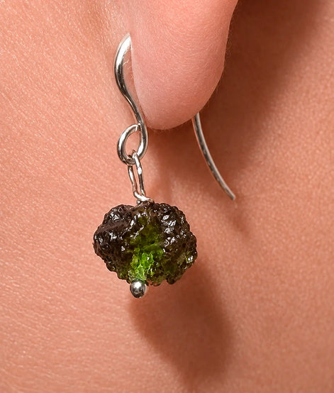 Raw drilled Chlum Moldavite earrings with naturally rounded green stones and rhodium-plated hooks.