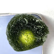 Large Bartochov Moldavite illuminated to reveal its translucent green colour
