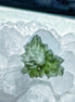 Transparent 1.34g Ježkovna Moldavite with spiked sculpting and a large open bubble