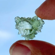 Transparent 1.34g Ježkovna Moldavite with spiked sculpting and a large open bubble