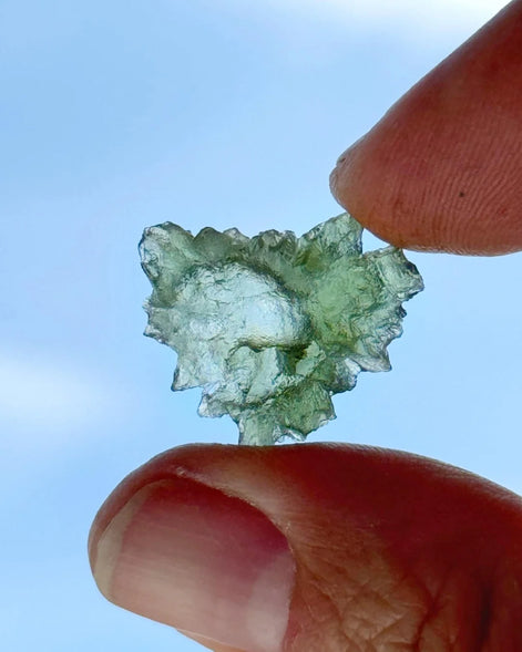 Transparent 1.34g Ježkovna Moldavite with spiked sculpting and a large open bubble