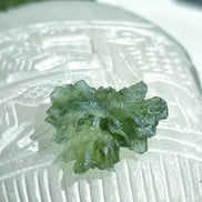 Transparent 1.34g Ježkovna Moldavite with spiked sculpting and a large open bubble