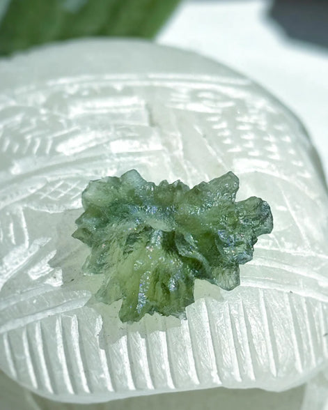 Transparent 1.34g Ježkovna Moldavite with spiked sculpting and a large open bubble
