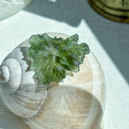 Transparent 1.34g Ježkovna Moldavite with spiked sculpting and a large open bubble