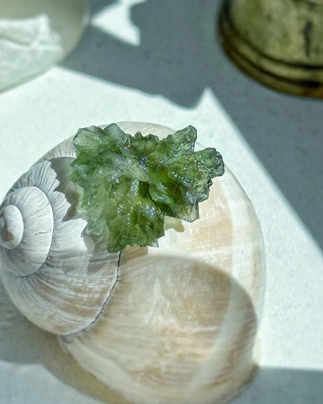 Transparent 1.34g Ježkovna Moldavite with spiked sculpting and a large open bubble