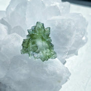 Transparent 1.34g Ježkovna Moldavite with spiked sculpting and a large open bubble