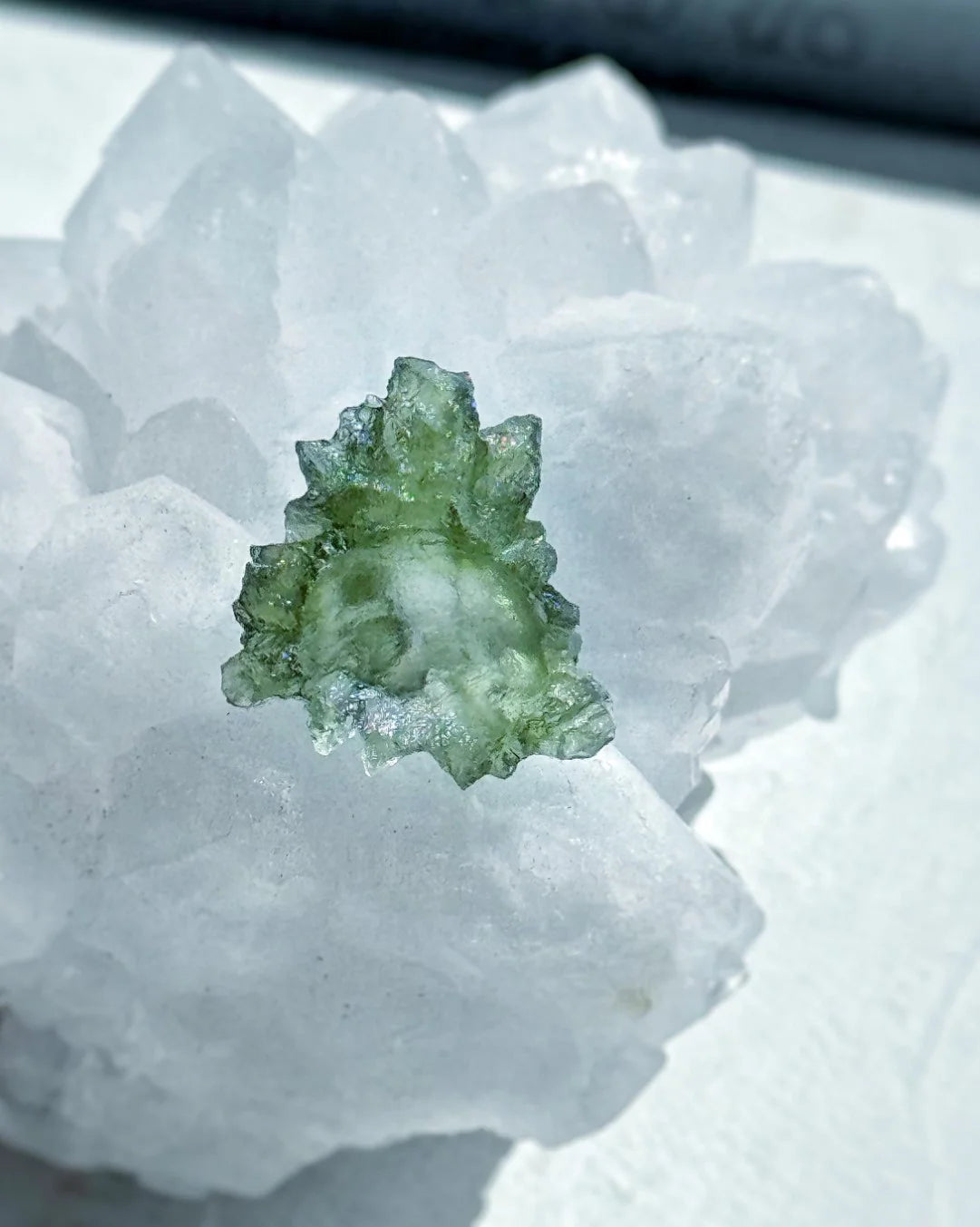 Transparent 1.34g Ježkovna Moldavite with spiked sculpting and a large open bubble