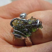 Adjustable moldavite ring with a 0.87g transparent green stone from Nesměň, featuring spiked sculpting in a tin and silver alloy setting.