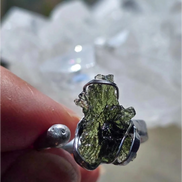 Adjustable moldavite ring with a 0.87g transparent green stone from Nesměň, featuring spiked sculpting in a tin and silver alloy setting.