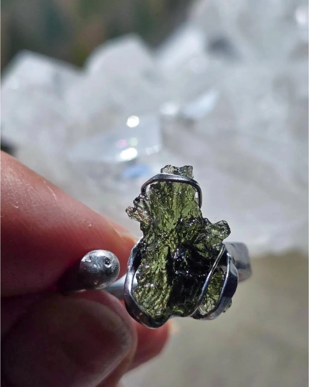 Adjustable moldavite ring with a 0.87g transparent green stone from Nesměň, featuring spiked sculpting in a tin and silver alloy setting.