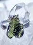 Adjustable moldavite ring with a 0.87g transparent green stone from Nesměň, featuring spiked sculpting in a tin and silver alloy setting.