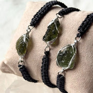 Moldavite bracelet beside ruler showing stone size