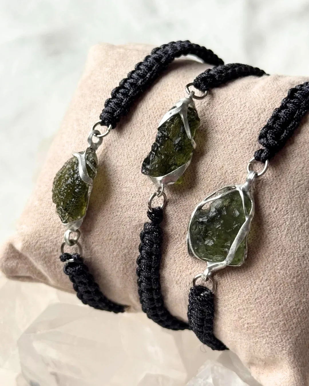 Moldavite bracelet beside ruler showing stone size