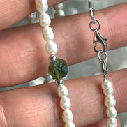 Alt text: Natural drilled 0.4g Chlum Moldavite necklace with freshwater pearls and sterling silver.