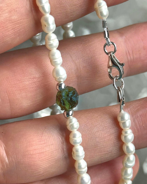 Alt text: Natural drilled 0.4g Chlum Moldavite necklace with freshwater pearls and sterling silver.