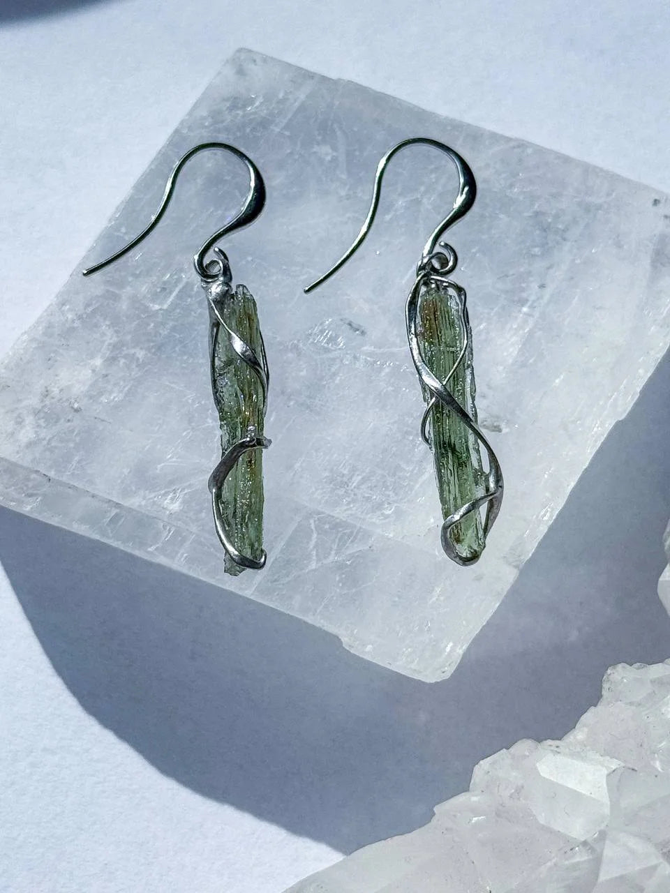 Raw Moldavite earrings with a 0.8 g pair of translucent green stones from Jankov, Czech Republic, in handcrafted open settings.