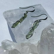 Raw Moldavite earrings with a 0.8 g pair of translucent green stones from Jankov, Czech Republic, in handcrafted open settings.
