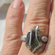 Adjustable ring with a genuine 1.23 g transparent green raw Moldavite from Chlum, Czech Republic, set in lead-free jewellery tin with silver admixture.
