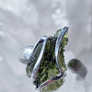 Adjustable ring with a genuine 1.23 g transparent green raw Moldavite from Chlum, Czech Republic, set in lead-free jewellery tin with silver admixture.
