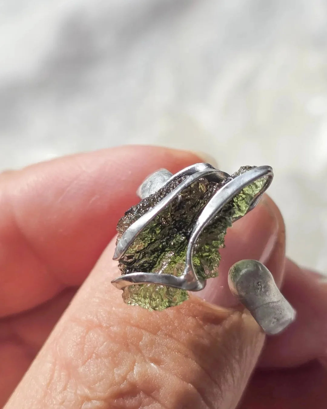 Adjustable ring with a genuine 1.23 g transparent green raw Moldavite from Chlum, Czech Republic, set in lead-free jewellery tin with silver admixture.
