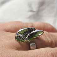 Adjustable ring with a genuine 1.23 g transparent green raw Moldavite from Chlum, Czech Republic, set in lead-free jewellery tin with silver admixture.
