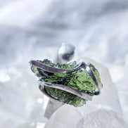 Adjustable ring with a genuine 1.23 g transparent green raw Moldavite from Chlum, Czech Republic, set in lead-free jewellery tin with silver admixture.
