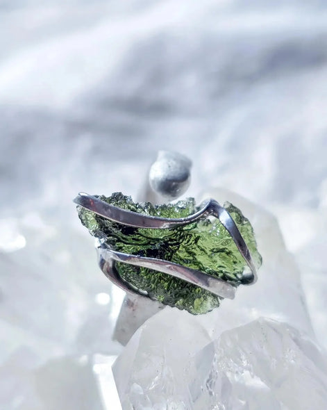 Adjustable ring with a genuine 1.23 g transparent green raw Moldavite from Chlum, Czech Republic, set in lead-free jewellery tin with silver admixture.
