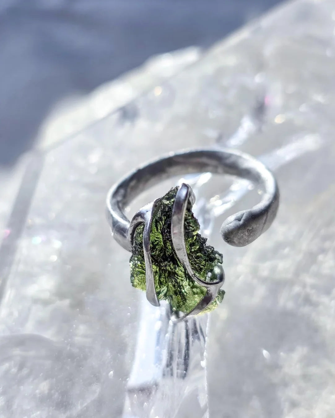 Adjustable ring with a genuine 1.23 g transparent green raw Moldavite from Chlum, Czech Republic, set in lead-free jewellery tin with silver admixture.
