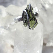 Adjustable ring with a genuine 1.23 g transparent green raw Moldavite from Chlum, Czech Republic, set in lead-free jewellery tin with silver admixture.
