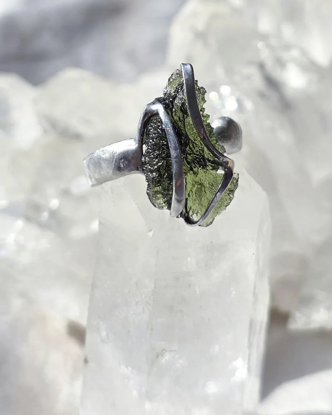 Adjustable ring with a genuine 1.23 g transparent green raw Moldavite from Chlum, Czech Republic, set in lead-free jewellery tin with silver admixture.
