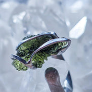 Adjustable ring with a genuine 1.23 g transparent green raw Moldavite from Chlum, Czech Republic, set in lead-free jewellery tin with silver admixture.
