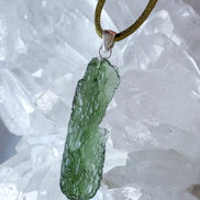 Transparent 3.6g Chlum Moldavite pendant with natural sculpted surface in sterling silver setting.
