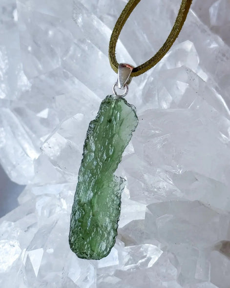 Transparent 3.6g Chlum Moldavite pendant with natural sculpted surface in sterling silver setting.