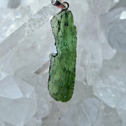 Transparent 3.6g Chlum Moldavite pendant with natural sculpted surface in sterling silver setting.