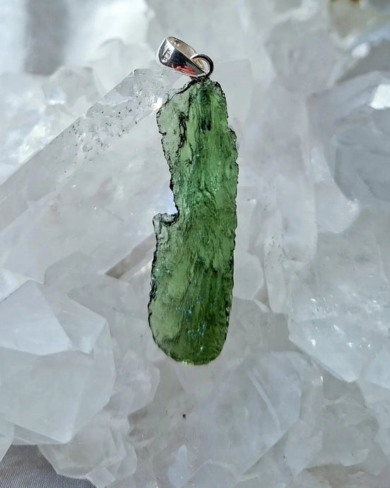Transparent 3.6g Chlum Moldavite pendant with natural sculpted surface in sterling silver setting.