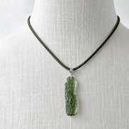Transparent 3.6g Chlum Moldavite pendant with natural sculpted surface in sterling silver setting.