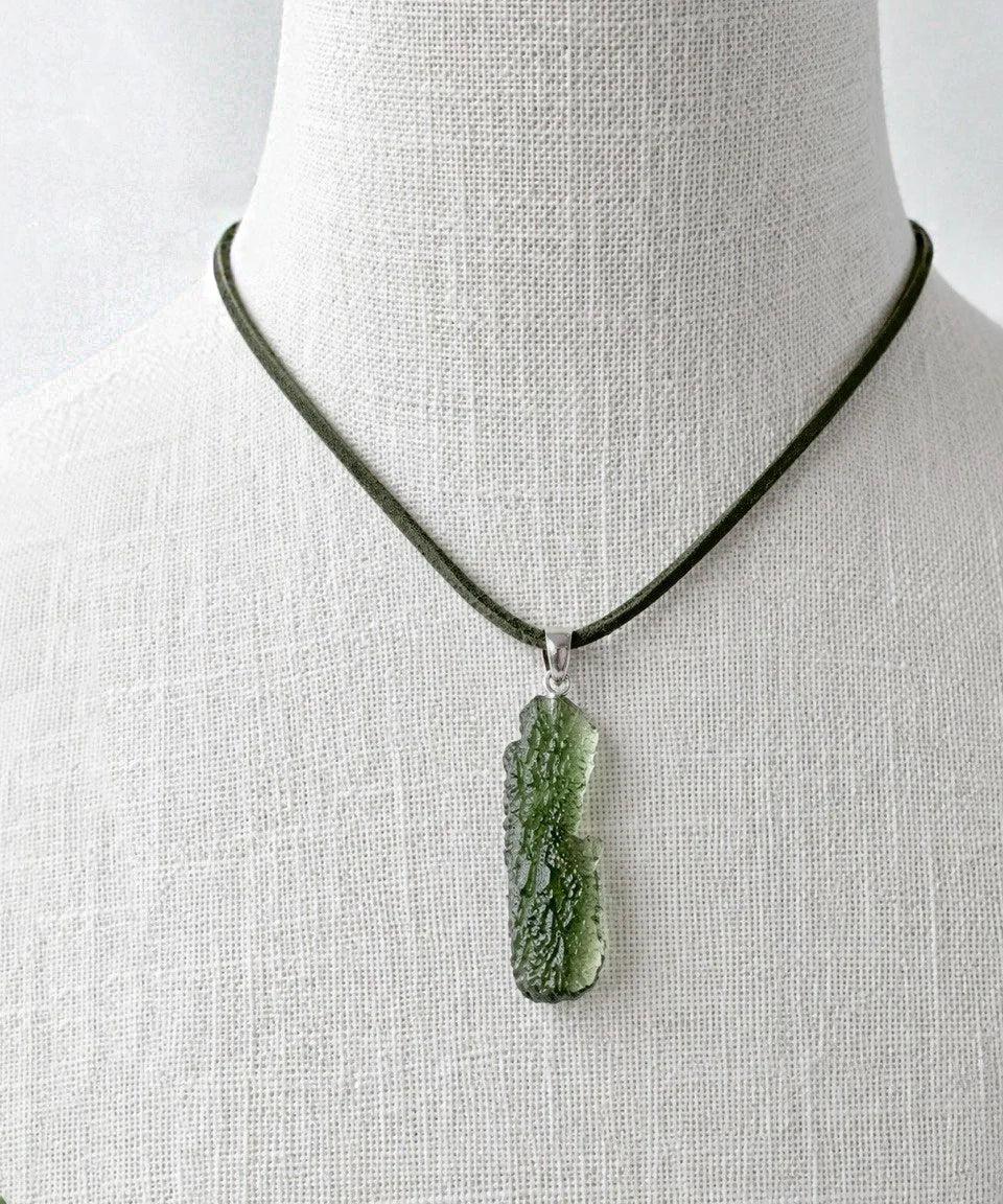 Transparent 3.6g Chlum Moldavite pendant with natural sculpted surface in sterling silver setting.