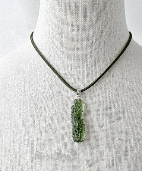 Transparent 3.6g Chlum Moldavite pendant with natural sculpted surface in sterling silver setting.