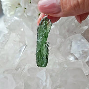 Transparent 3.6g Chlum Moldavite pendant with natural sculpted surface in sterling silver setting.