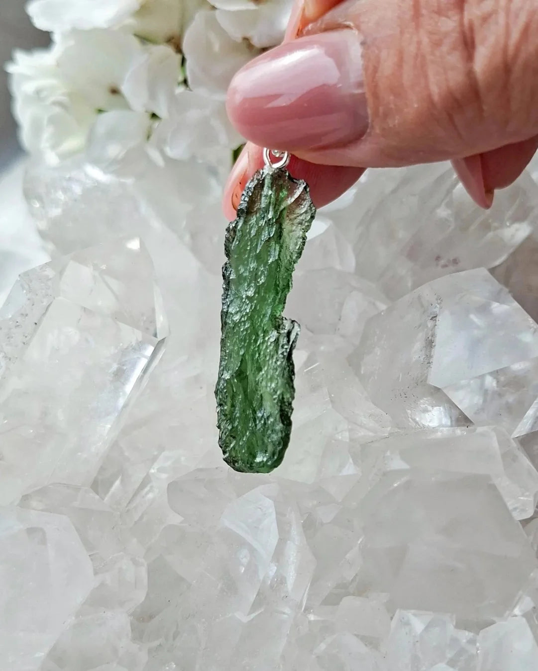 Transparent 3.6g Chlum Moldavite pendant with natural sculpted surface in sterling silver setting.