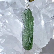 Transparent 3.6g Chlum Moldavite pendant with natural sculpted surface in sterling silver setting.