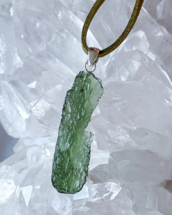 Transparent 3.6g Chlum Moldavite pendant with natural sculpted surface in sterling silver setting.