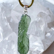 Transparent 3.6g Chlum Moldavite pendant with natural sculpted surface in sterling silver setting.