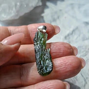 Transparent 3.6g Chlum Moldavite pendant with natural sculpted surface in sterling silver setting.