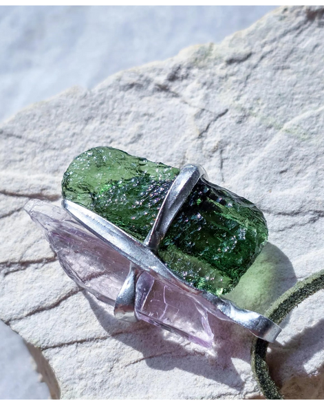 Pendant with 3.49g apple green moldavite from Ločenice and pale pink kunzite held by crossing metal bands.