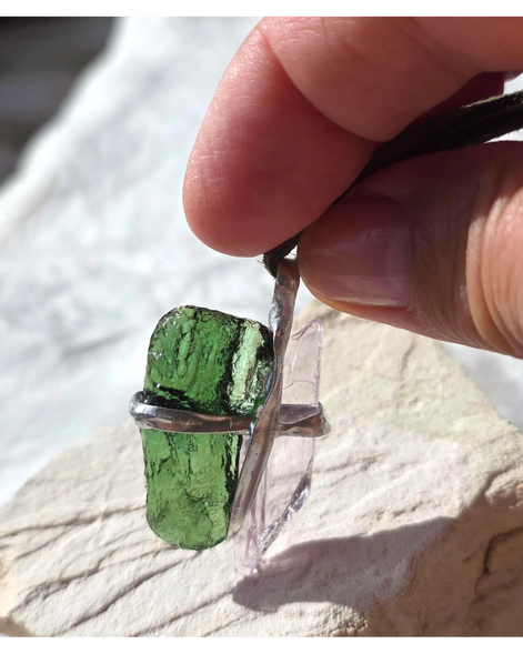 Pendant with 3.49g apple green moldavite from Ločenice and pale pink kunzite held by crossing metal bands.